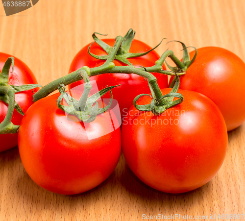 Image of Freshly picked red tomatoes on a table top 