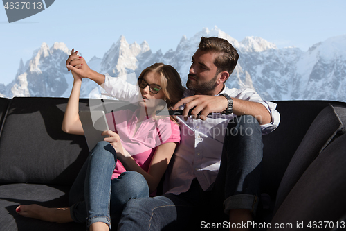 Image of Young couple watching television