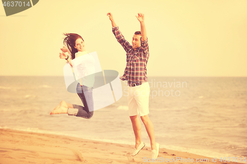 Image of happy young couple have fun on beach