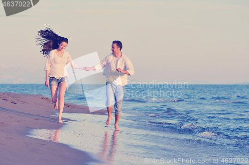 Image of young couple  on beach have fun