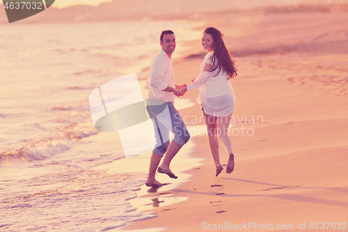 Image of young couple  on beach have fun