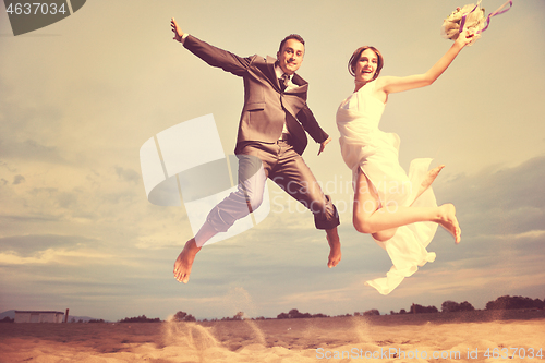 Image of romantic beach wedding at sunset