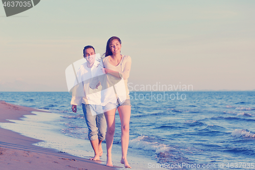 Image of young couple  on beach have fun