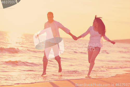 Image of young couple  on beach have fun