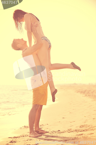 Image of happy young couple have romantic time on beach