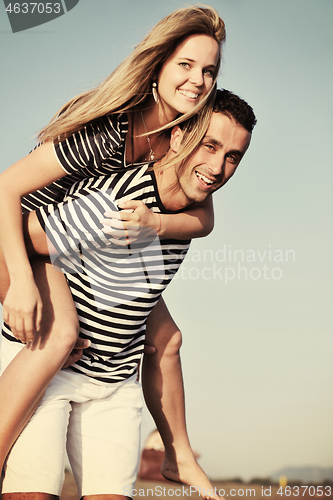 Image of happy young couple have romantic time on beach