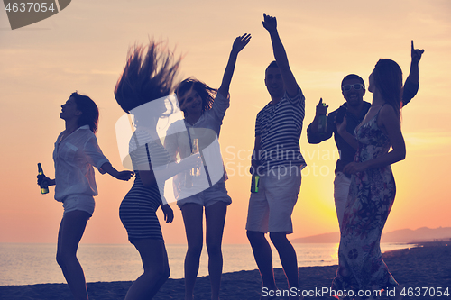 Image of Group of young people enjoy summer  party at the beach