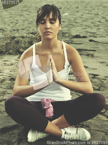 Image of woman yoga beach