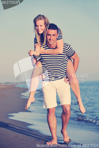 Image of happy young couple have romantic time on beach