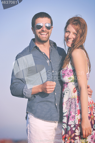 Image of happy young couple have romantic time on beach