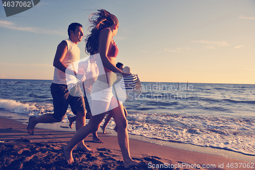 Image of people group running on the beach