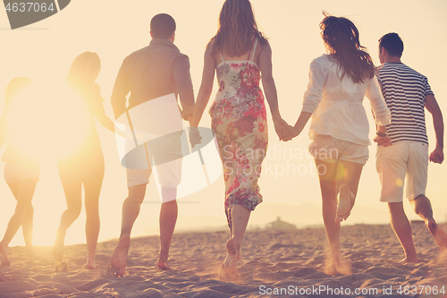 Image of happy young  people group have fun on beach