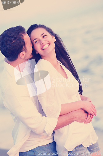 Image of young couple  on beach have fun