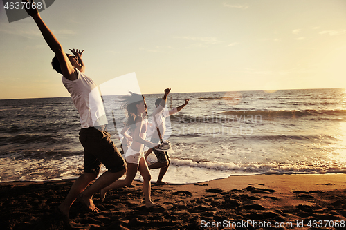 Image of people group running on the beach