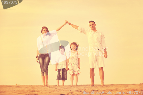 Image of family on beach showing home sign