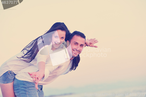 Image of young couple  on beach have fun