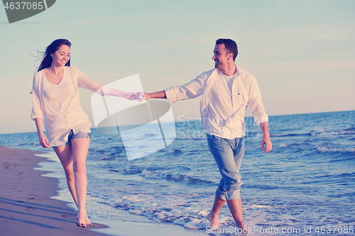 Image of young couple  on beach have fun