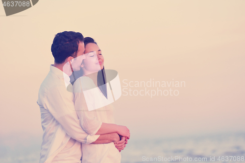 Image of young couple  on beach have fun