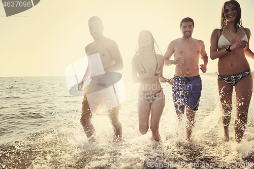 Image of happy people group have fun and running on beach