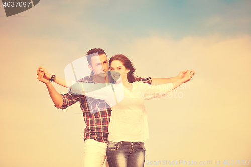 Image of happy young couple have fun on beach