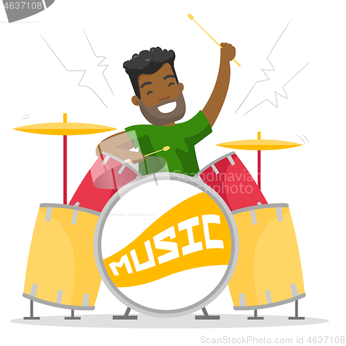 Image of Young african-american man playing on drum kit.