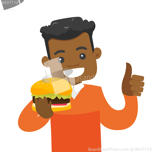 Image of Young african-american man eating hamburger.