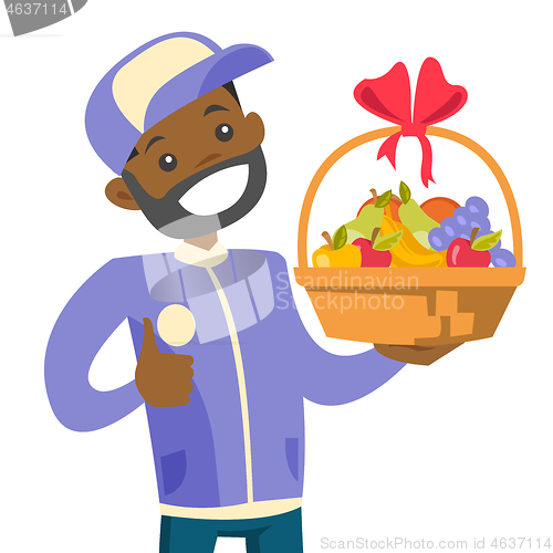 Image of African delivery courier delivering fruit basket.