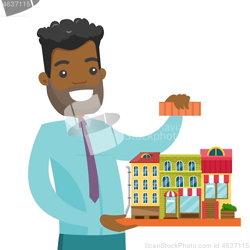 Image of African real estate agent presenting city model.