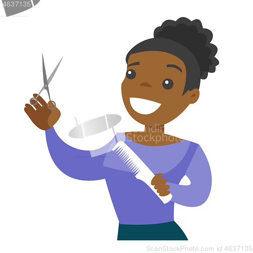 Image of Hairdresser holding comb and scissors in hands.