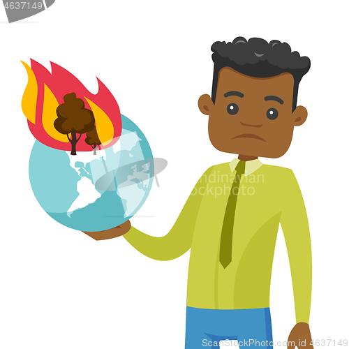 Image of African man holding globe with forest in fire.
