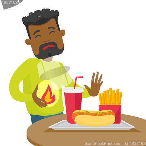 Image of Sad african-american man suffering from heartburn.