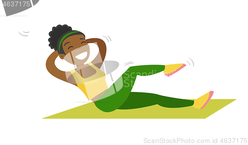 Image of Young african-american woman doing crunches.