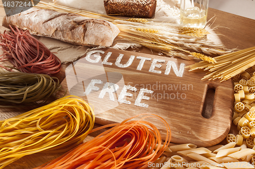 Image of Gluten free food. Various pasta, bread and snacks on wooden background from top view