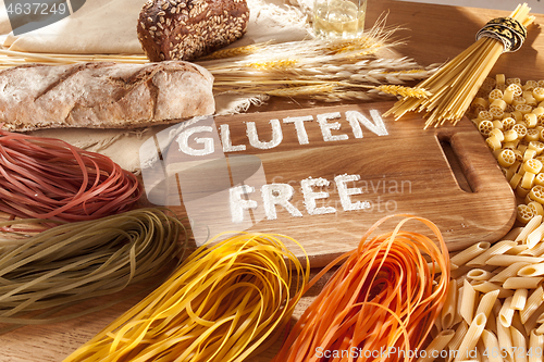 Image of Gluten free food. Various pasta, bread and snacks on wooden background from top view