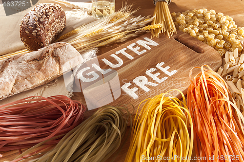 Image of Gluten free food. Various pasta, bread and snacks on wooden background from top view