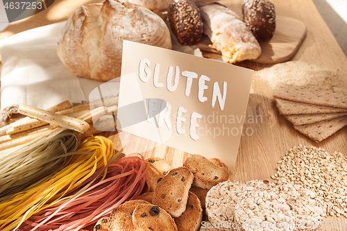 Image of Gluten free food. Various pasta, bread and snacks on wooden background from top view