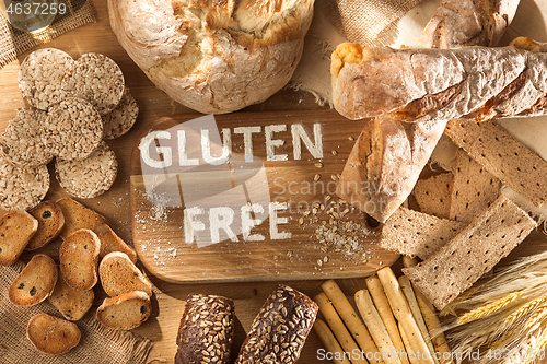 Image of Gluten free food. Various pasta, bread and snacks on wooden background from top view