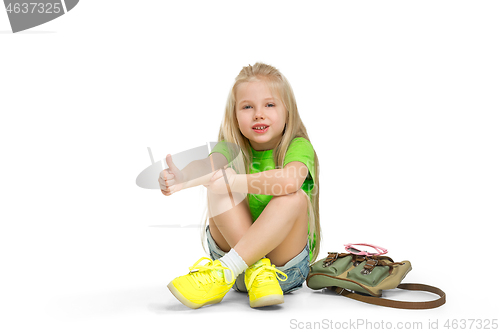 Image of Full length portrait of cute little kid in stylish jeans clothes looking at camera and smiling