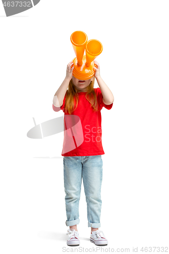 Image of Full length portrait of cute little kid in stylish jeans clothes looking at toy binoculars