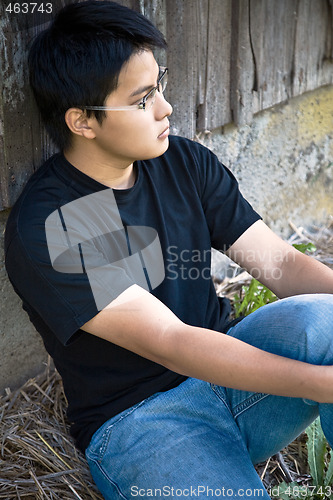 Image of Asian sitting alone