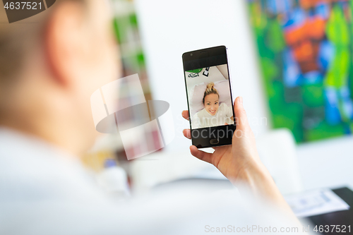 Image of Woman at home using social media on phone for video chatting with her loved ones during corona virus pandemic. Stay at home, social distancing lifestyle.