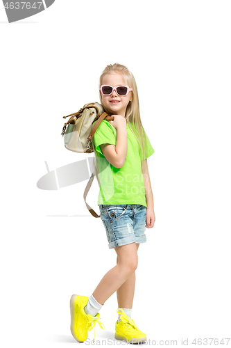Image of Full length portrait of cute little kid in stylish jeans clothes looking at camera and smiling