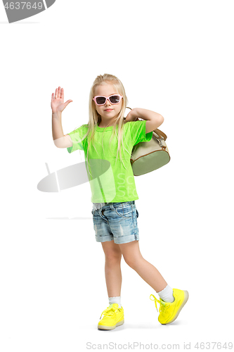 Image of Full length portrait of cute little kid in stylish jeans clothes looking at camera and smiling