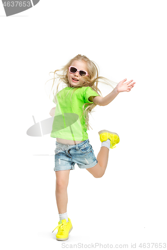 Image of Full length portrait of cute little kid in stylish jeans clothes looking at camera and smiling