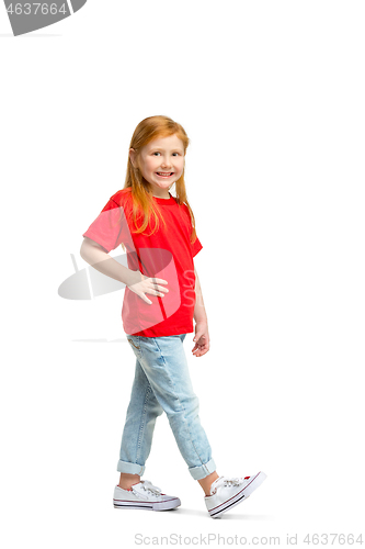 Image of Full length portrait of cute little kid in stylish jeans clothes looking at camera and smiling