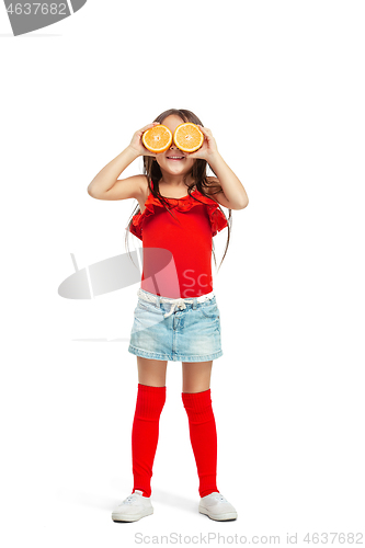 Image of Full length portrait of cute little kid in stylish jeans clothes with orange