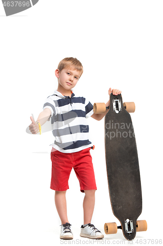 Image of Full length portrait of an adorable young boy riding a skateboard isolated against white background