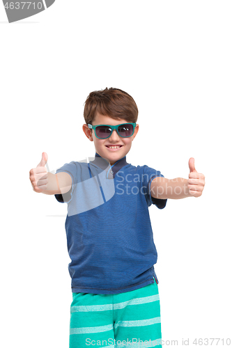 Image of Full length portrait of cute little kid in stylish clothes looking at camera and smiling