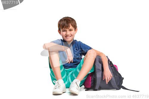 Image of Full length portrait of cute little kid in stylish clothes looking at camera and smiling