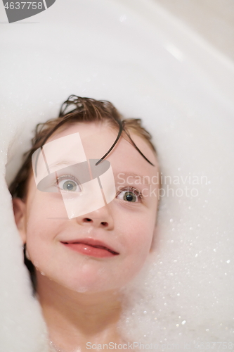 Image of little girl in bath playing with soap foam